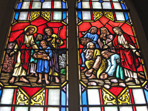 The stained glass windows in the nave pair New Testament scenes with those in the Old Testament that prefigure them. Here we see, on the left the New Testament multiplication of the loaves and fish and Bread of Life discourse paired with the Old Testament story of the Manna in the desert. 